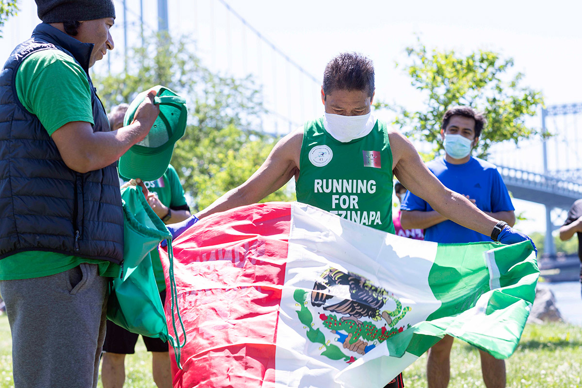 Running for Ayotzinapa 43 - Two runners carrying the Mexican flag